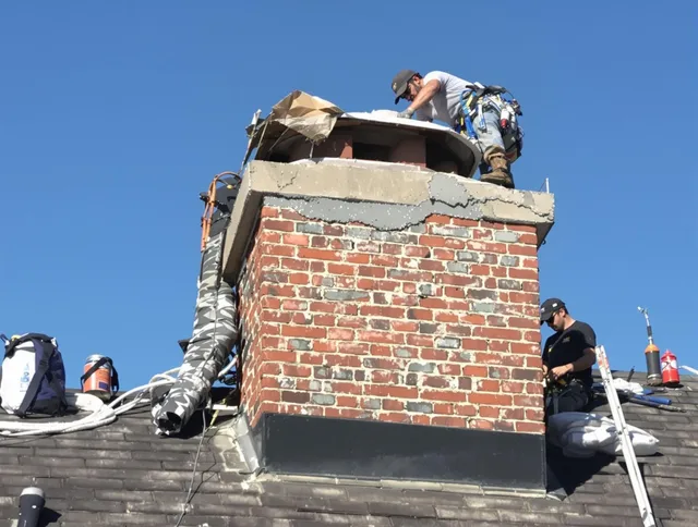 Lyndhurst Chimney Sweep installing a custom chimney crown in Lyndhurst, OH