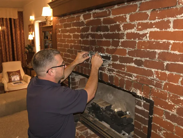 Lyndhurst Chimney Sweep expert fixing a fireplace in Lyndhurst, OH